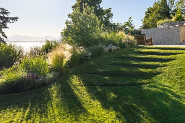 steel steps cutting into lawn grass view of puget sound