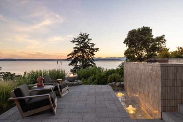 view of puget sound infinity edge hot tub with tile and fountain firepit
